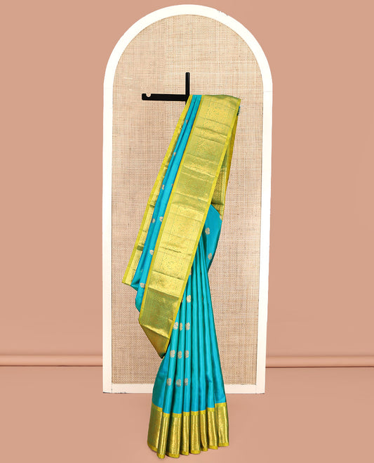 Blue Kanchipuram Silk Saree, Decorated with Mayil Buttas All Over Its Body, Complemented by a Contrast Border of Thilakam Mokku, Laddu Kamalam, and Mayil Designs, Pallu of Gandaberunda Designs, and Paired with a Contrast Blouse
