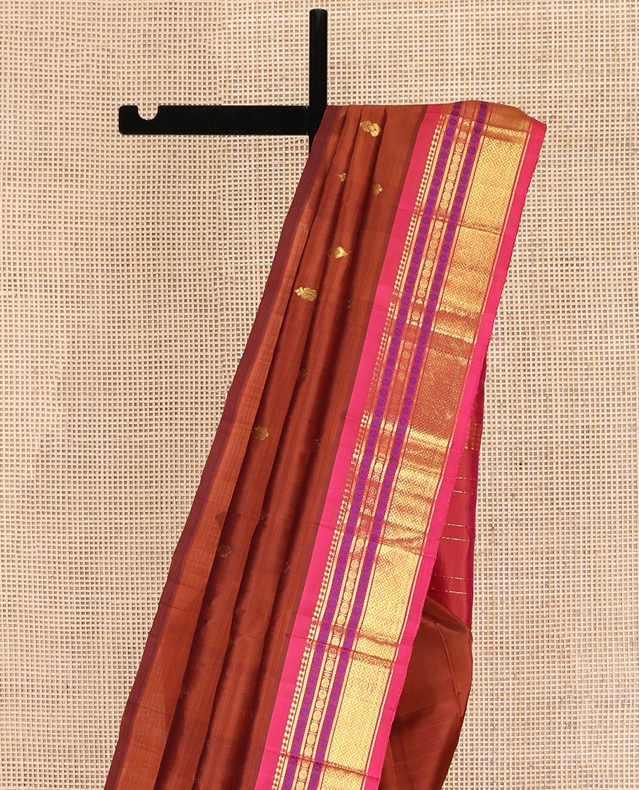 Brown Kanchipuram Silk Saree, Woven with Zari Buttas on Its Body, Complemented by a Contrast One-Sided Border of Panner Sombu, Banaras, Rudraksham, and Mayil Kann Designs, Pallu of Zari Designs, and Comes Without a Blouse