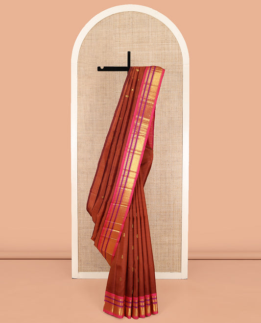 Brown Kanchipuram Silk Saree, Woven with Zari Buttas on Its Body, Complemented by a Contrast One-Sided Border of Panner Sombu, Banaras, Rudraksham, and Mayil Kann Designs, Pallu of Zari Designs, and Comes Without a Blouse