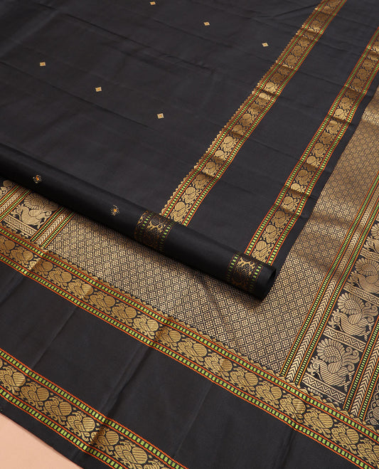 Black buttas Kanchipuram silk saree, rettai pettu border of rekku, muthu, and mayil designs, and jaal pallu