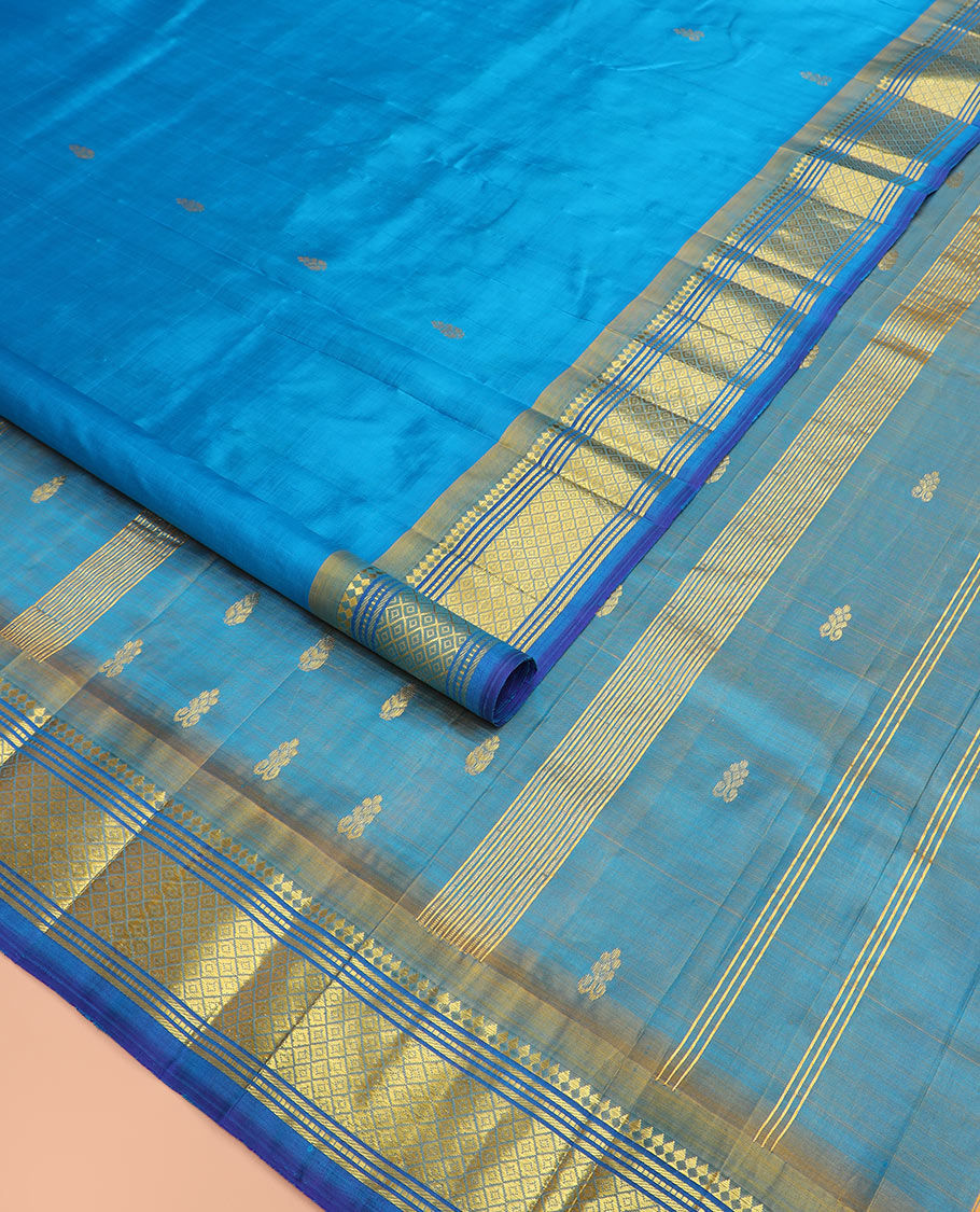 Blue zari buttas Kanchipuram silk saree, contrast border of paneer sombu, banaras, muthu, and mayil kann, and zari design pallu