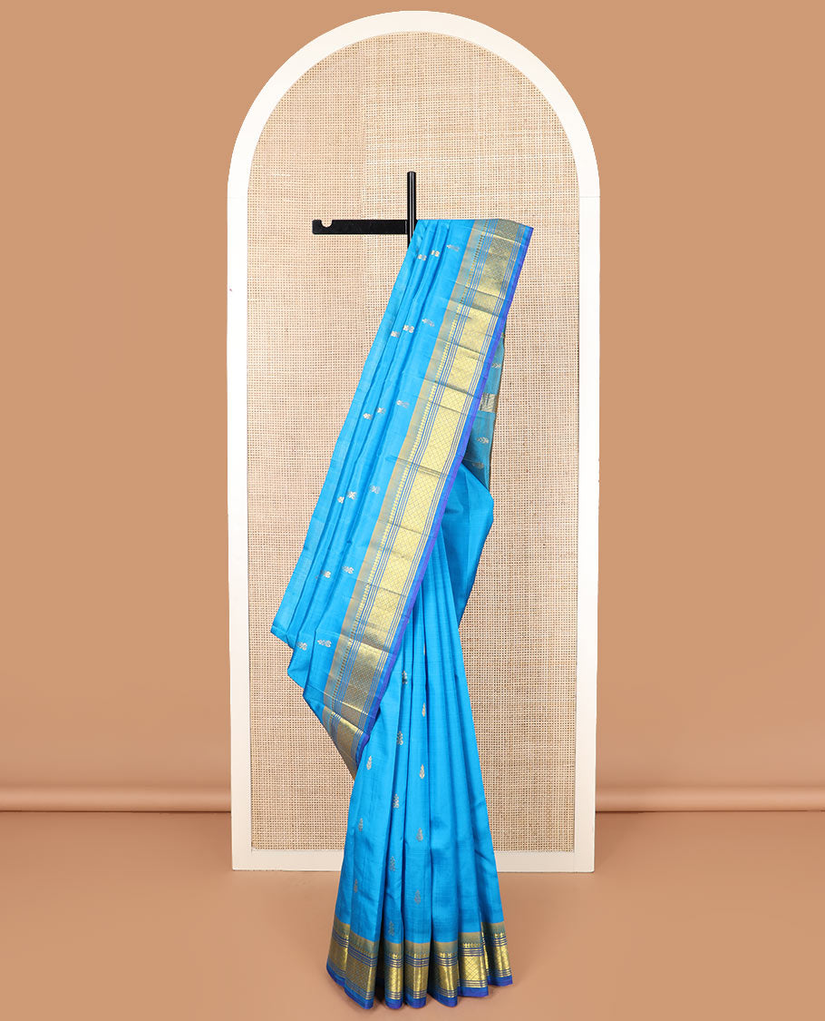 Blue zari buttas Kanchipuram silk saree, contrast border of paneer sombu, banaras, muthu, and mayil kann, and zari design pallu