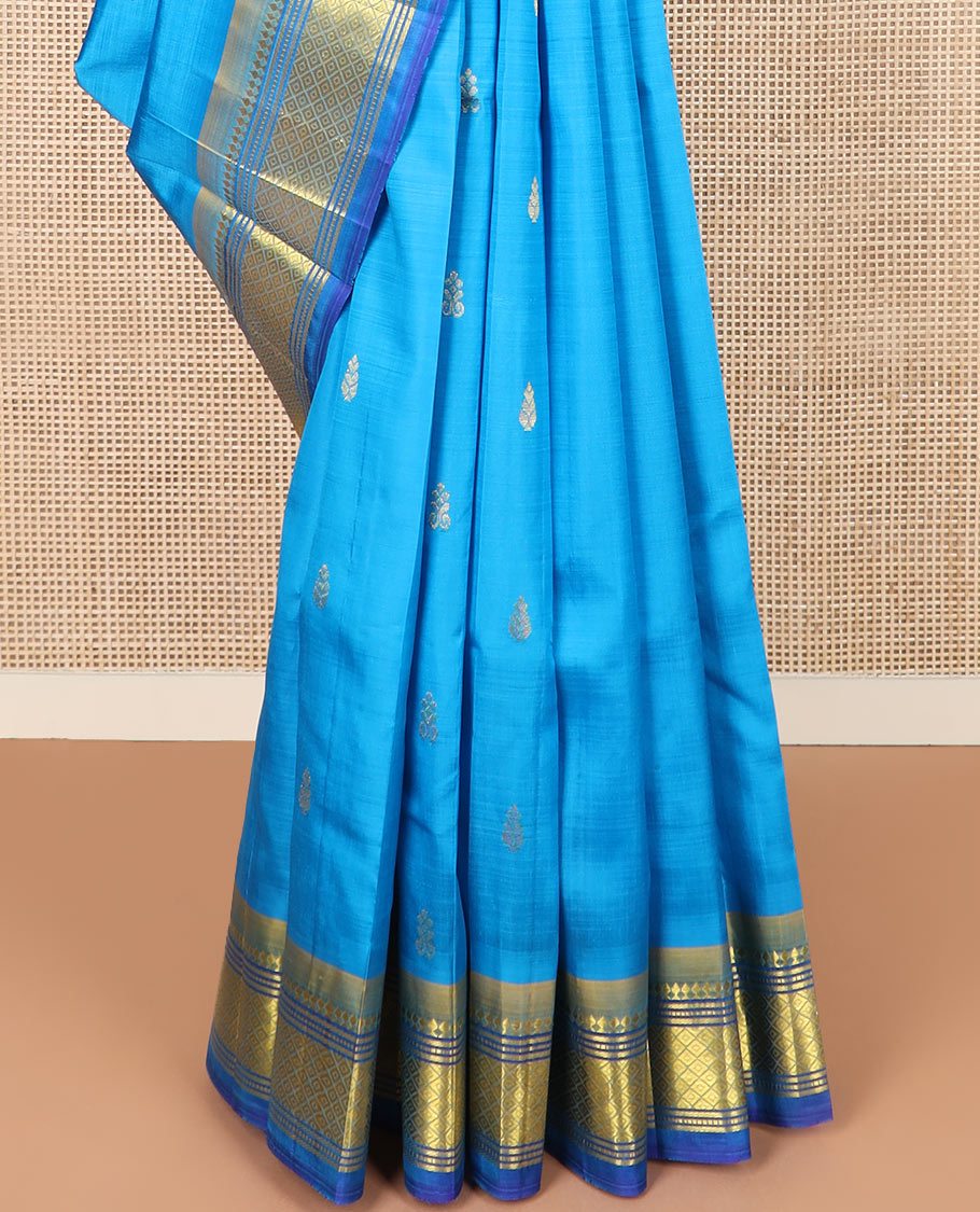 Blue zari buttas Kanchipuram silk saree, contrast border of paneer sombu, banaras, muthu, and mayil kann, and zari design pallu