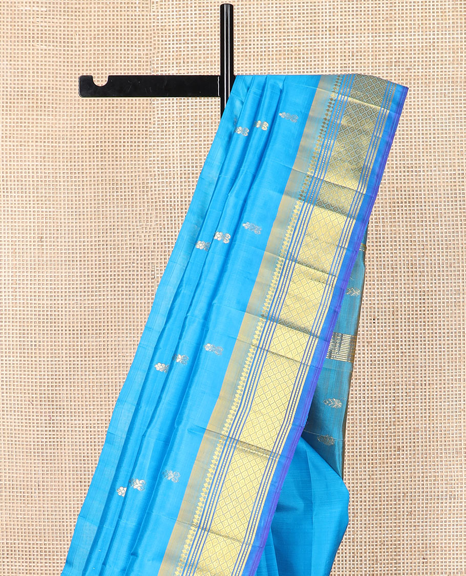 Blue zari buttas Kanchipuram silk saree, contrast border of paneer sombu, banaras, muthu, and mayil kann, and zari design pallu