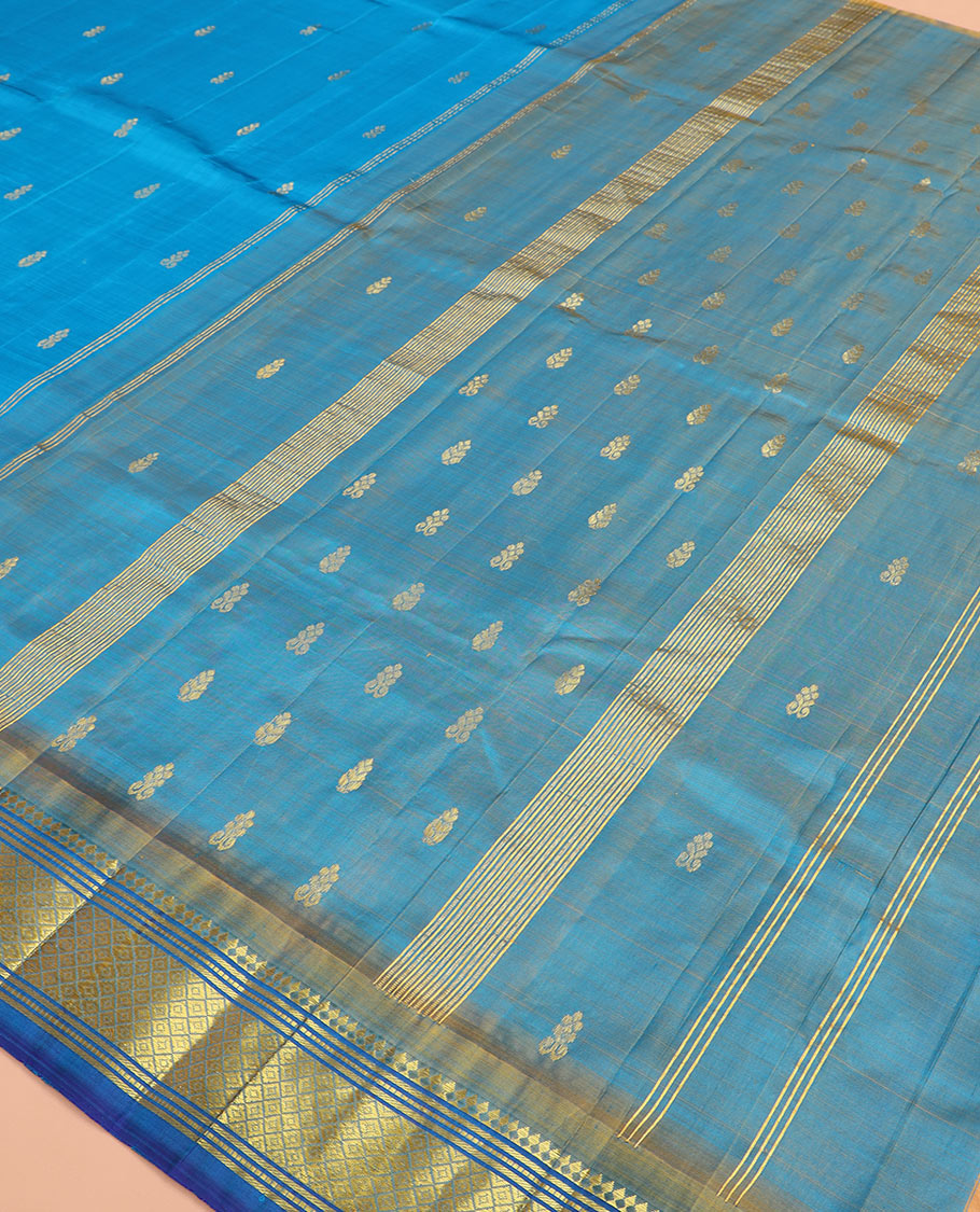 Blue zari buttas Kanchipuram silk saree, contrast border of paneer sombu, banaras, muthu, and mayil kann, and zari design pallu