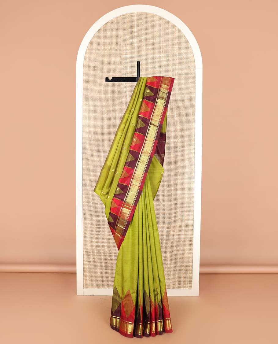 Green zari buttas Kanchipuram silk saree, contrast one-sided thazampoo rekku border of thilakam mokku, and jaal designs, and zari design pallu