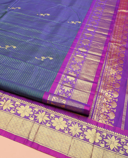 Blue Kanchipuram Silk Saree Adorned with Zari Buttas, Complemented by Contrast One-Sided Border of Rekku, Banaras, Floral, and Jaal Designs, Grand Pallu of Floral-Paisley Designs, and Comes Without a Blouse