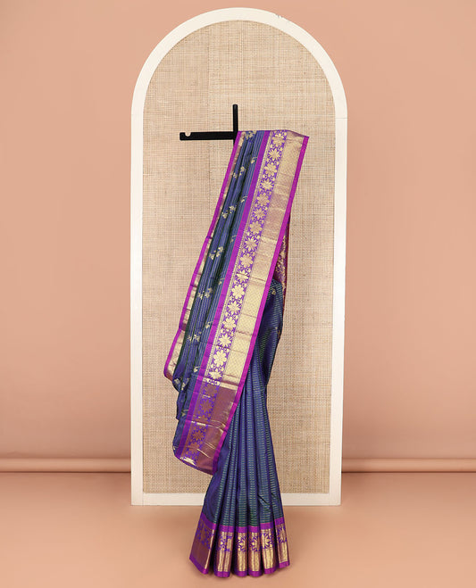 Blue Kanchipuram Silk Saree Adorned with Zari Buttas, Complemented by Contrast One-Sided Border of Rekku, Banaras, Floral, and Jaal Designs, Grand Pallu of Floral-Paisley Designs, and Comes Without a Blouse