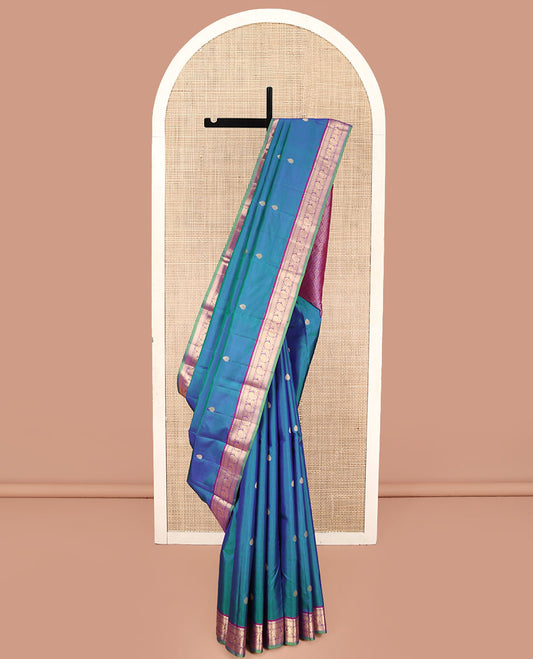 Blue Kanchipuram Silk Saree, Mesmerized with Zari Buttas All Over Its Body, Complemented by a Contrast Border of Thilakam, Mayil Kann, Muthu, and Mayil Designs, Grand Jaal Pallu, and Paired with a Contrast Blouse