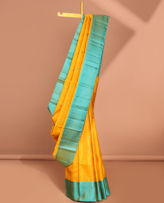 Yellow round buttas kancheepuram silk sare with contrast argyle border & intricate zari pallu
