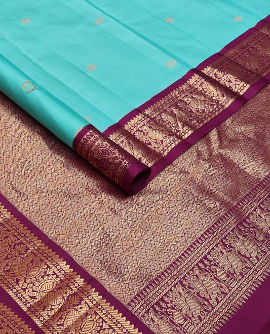 Light blue zari buttas silk saree, contrast border of rekku, diamond & mayil designs & jaal pallu