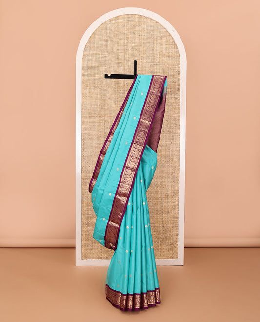 Light blue zari buttas silk saree, contrast border of rekku, diamond & mayil designs & jaal pallu