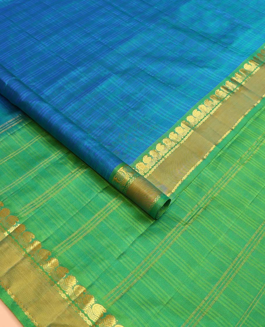Blue checked Kanchipuram silk saree, contrast rettai pettu border of manga, neli, and diamond designs, and striped pallu
