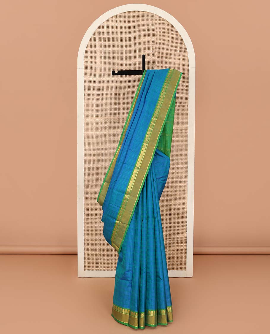 Blue checked Kanchipuram silk saree, contrast rettai pettu border of manga, neli, and diamond designs, and striped pallu