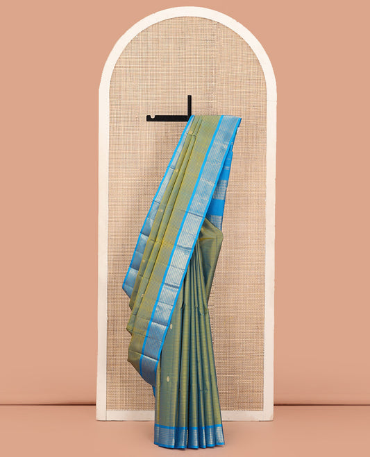 Green Kanchipuram Silk Saree Adorned with Vazhaipoo Stripes and Zari Buttas, Complemented by Contrast Border of Banaras and Lavangam Designs, Subtly Zariwoven Pallu, and Paired with a Contrast Blouse