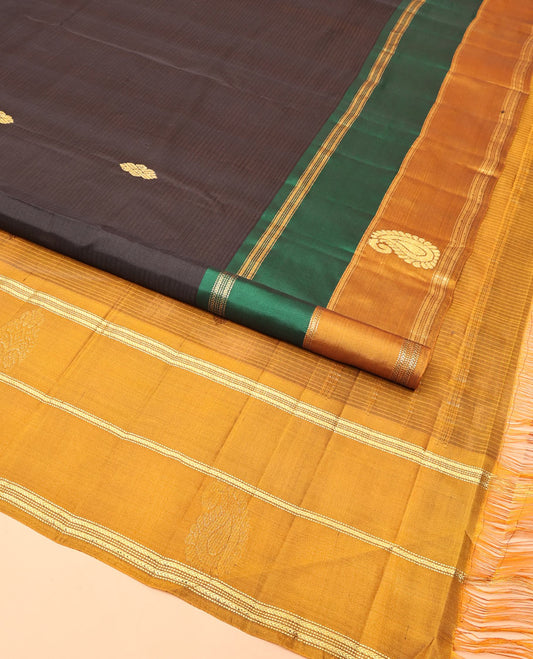 Black Kanchipuram Silk Saree, Mesmerized with Buttas and Vazhaipoo Stripes All Over Its Body, Complemented by a Contrast Border of Muthu, Kathir, and Arumbu Manga Designs, Sparsely Woven Pallu, and Paired with a Contrast Blouse