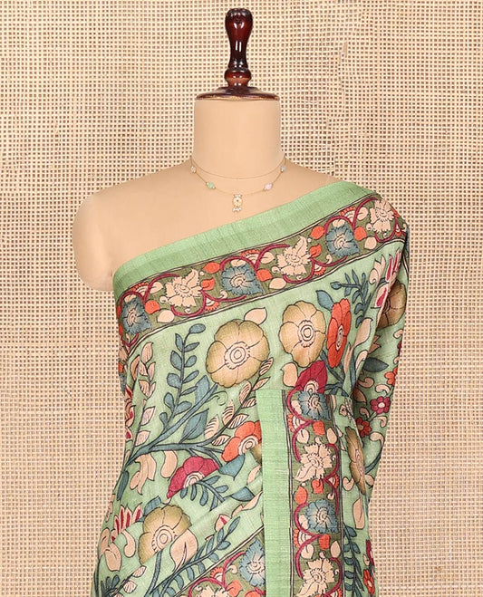 Pista Green Semi-Tussar Saree Colorfully Highlighted with Kalamkari-Style Floral Vine Print, Self-Colored Printed Border of Floral Print, Pallu Depicting Kalamkari Floral-Peacock Print, and Paired with a Matching Blouse