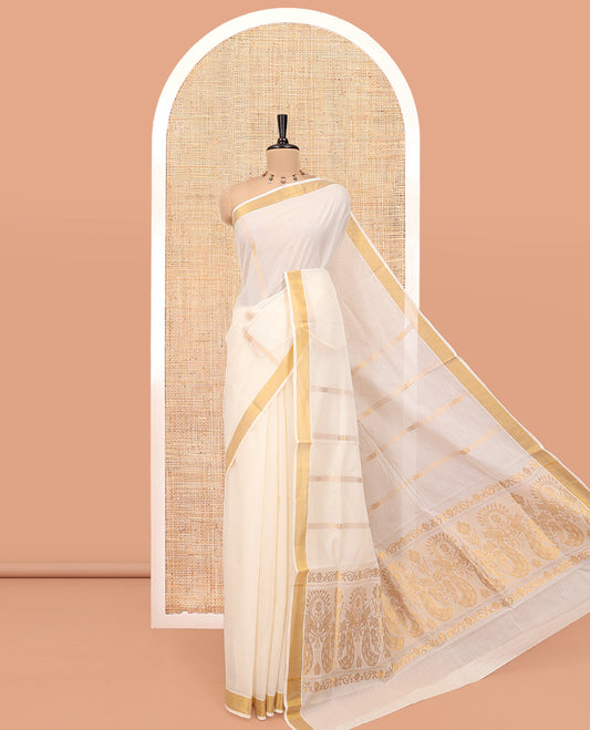 Cream Kerala Cotton Saree, Enlivened with Zari Stripes All Over Its Body, a Subtle Bavanji Border, Pallu Depicts Peacock Designs, and Paired with a Matching Blouse