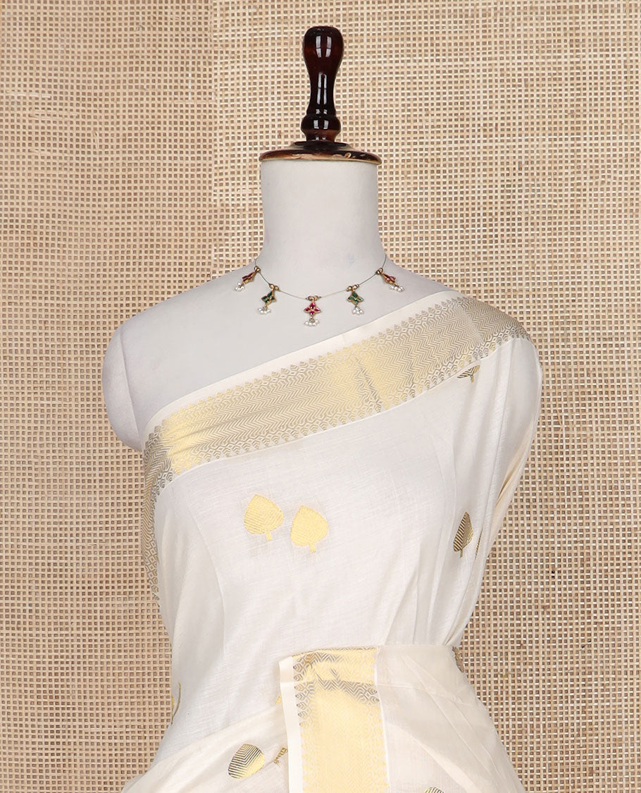 Cream pine tree zari buttas Kerala saree, traditional zari border, and pallu of pine tree motifs