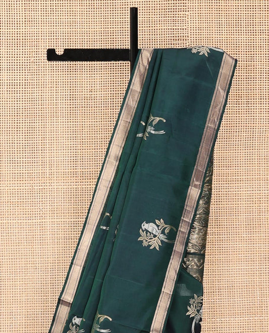 Green Mayuri Soft Silk Saree, Bedecked with Bird Buttas All Over Its Body, Highlighted by Zari Piping Border, Pallu of Floral Jaal and Bird Designs, and Paired with a Matching Blouse