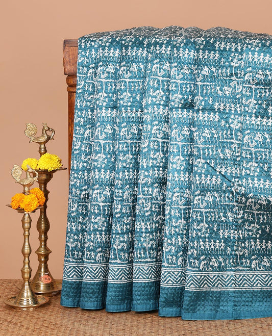 Blue batik-style warli printed Litch crushed saree, batik chevron border, floral-geometric printed pallu & triangle motif blouse