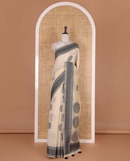 Chikku and black munga cotton saree with round tree buttas, traditional thread motifs woven border, round tree motifs pallu, and thread woven blouse