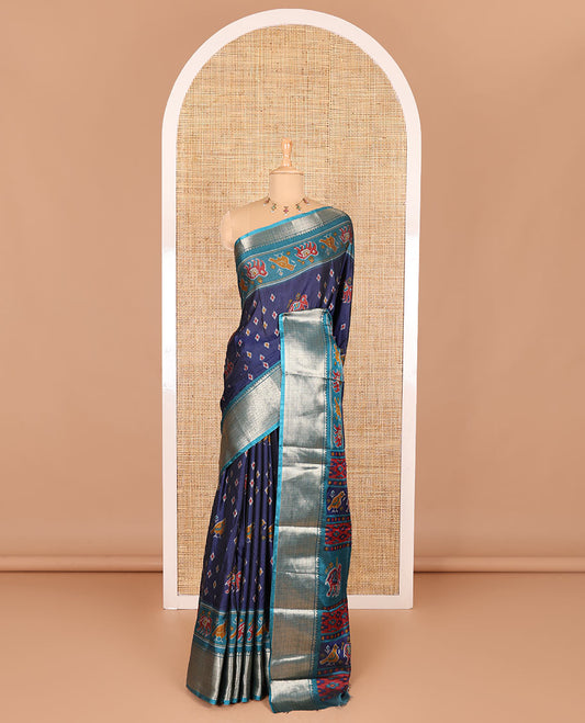Navy blue patola elephant motifs printed Dola silk saree, contrast zari border, and pallu of animal patola motifs print, and a contrast butta printed blouse