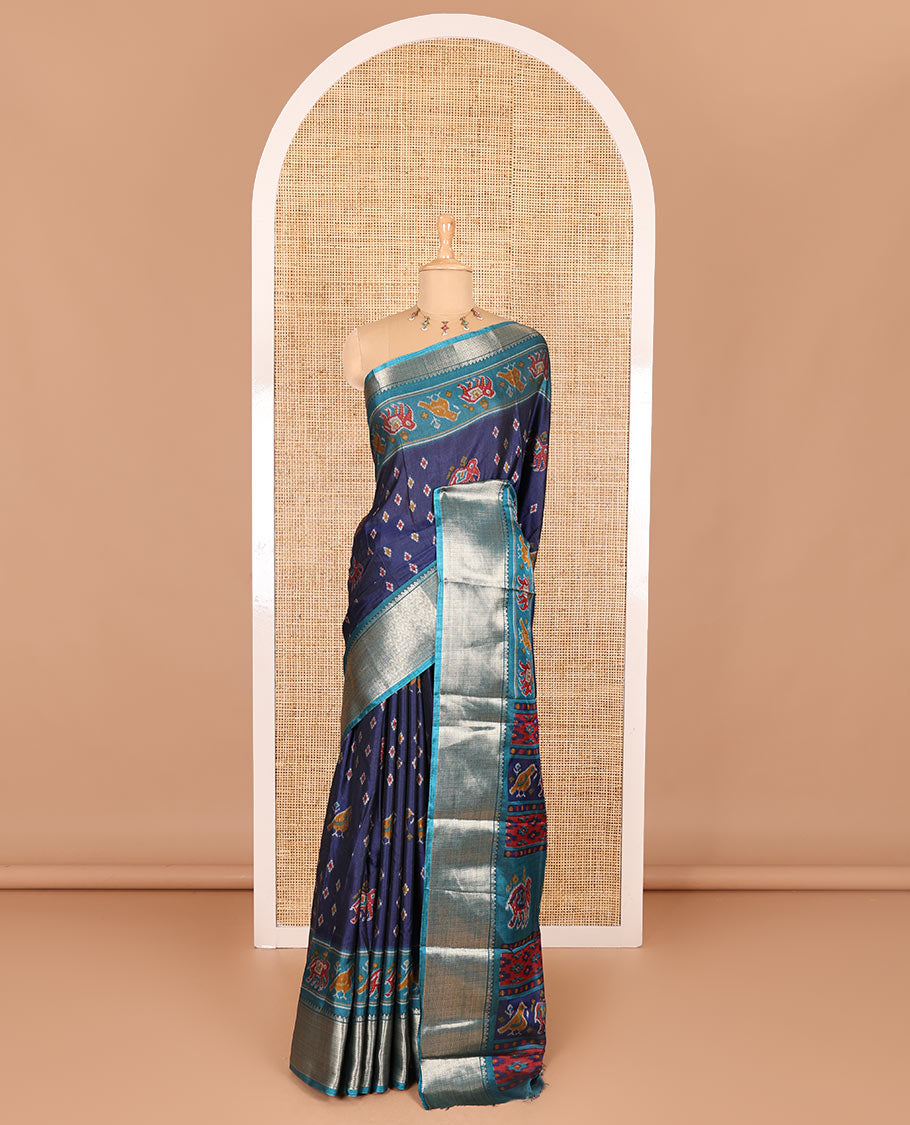 Navy blue patola elephant motifs printed Dola silk saree, contrast zari border, and pallu of animal patola motifs print, and a contrast butta printed blouse