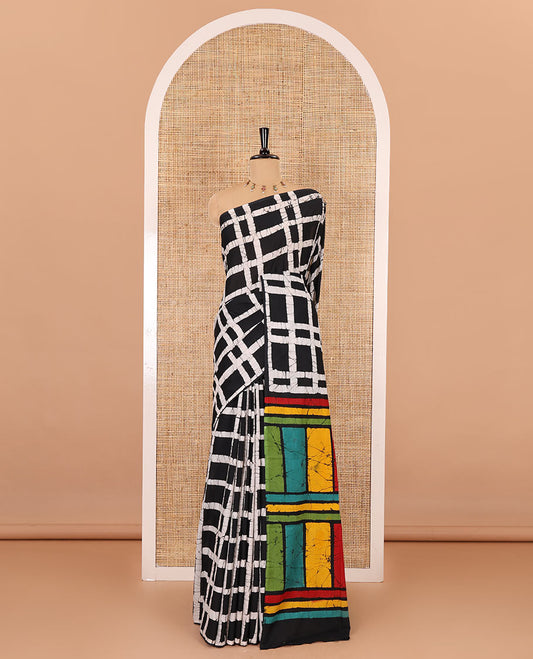 Black checked batik printed mul cotton saree, contrast kaleidoscope colored batik printed pallu, and a contrast batik printed blouse