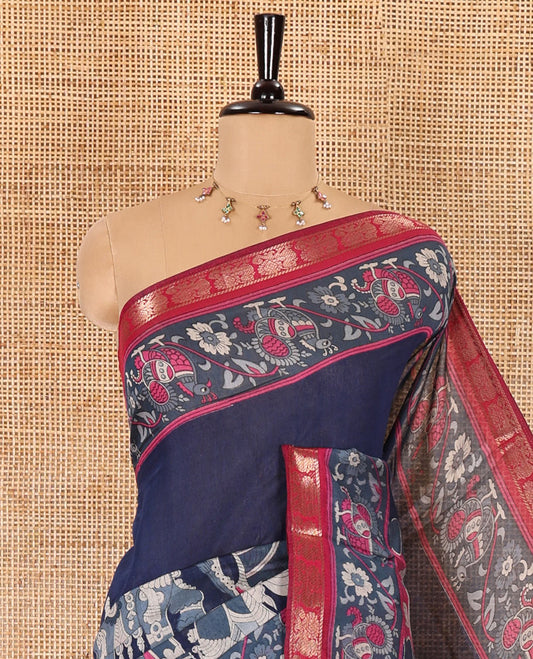 Navy blue kalamkari ancient human figurines machine-printed muslin cotton saree, contrast traditional design zari border, kalamkari printed pallu, and contrast floral motifs and zari bordered blouse