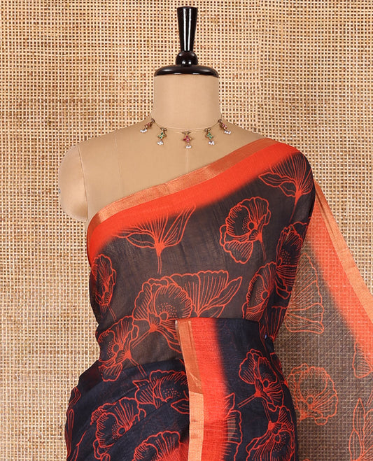 Black floral printed linen cotton saree, contrast piping border, kalamkari floral and peacock printed pallu, and a contrast floral vine printed blouse