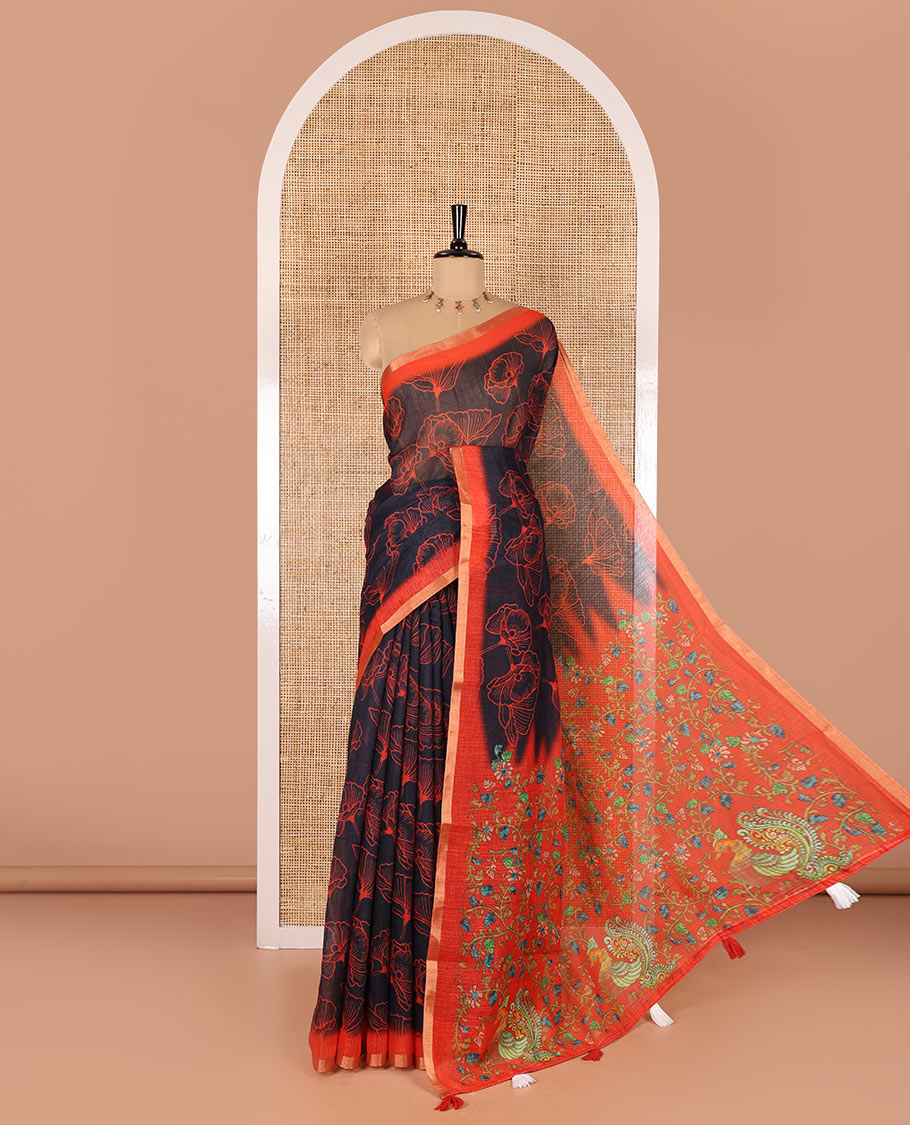 Black floral printed linen cotton saree, contrast piping border, kalamkari floral and peacock printed pallu, and a contrast floral vine printed blouse