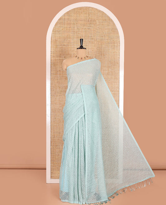 Borderless sea green sparkling glittered russel net saree, self-pallu and a floral print with zig-zag embroidered blouse