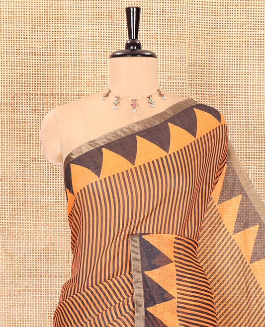 Orange vertical stripes printed linen cotton saree, a temple-printed border, big polka dot printed pallu, and a printed blouse