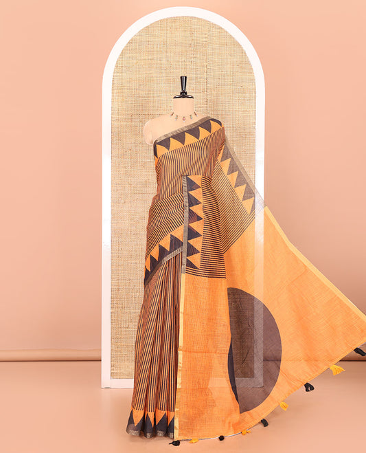 Orange vertical stripes printed linen cotton saree, a temple-printed border, big polka dot printed pallu, and a printed blouse