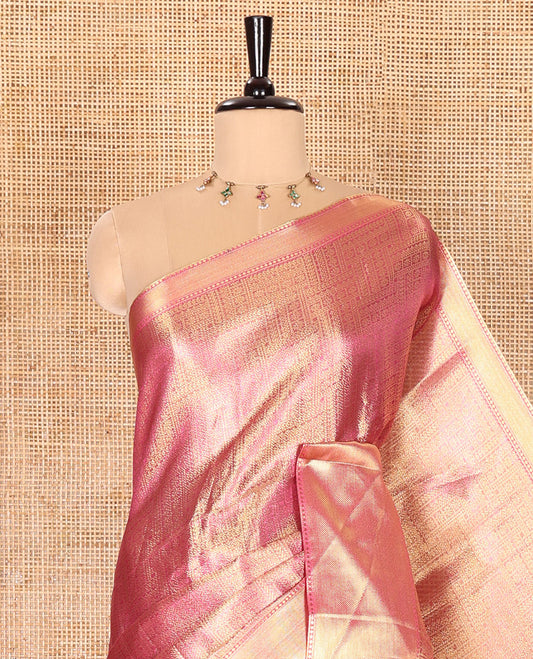 Rani Pink Tissue Saree Features Floral Jacquard Design Woven All Over Its Body, Features a Contrast Gleaming Zari Traditional Design Border, Zari-Enriched Pallu, and a Matching Blouse