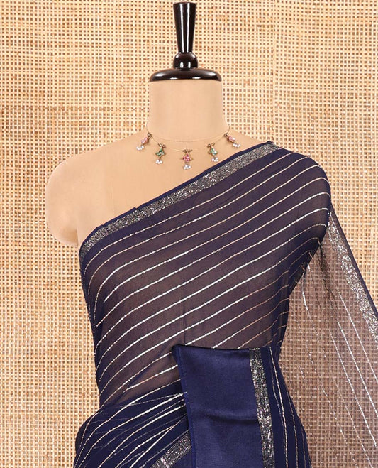 Navy Blue Viscose Georgette Saree Gleamed with Horizontal Golden Zari Stripes All Over Its Body, Accentuated by a Satin Plain Border, a Self Pallu Featuring the Same Horizontal Stripes, and Paired with a Running Blouse