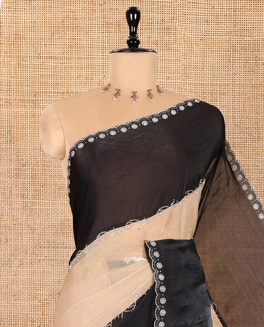 Chikku and Black Fendy Satin Saree Spotlighted with Rangoli-Style Swarovski Stone Work All Over Its Body, Complemented by Contrast Big Swarovski Stone Work Scallop Border, and Paired with a Contrast Stone Work Blouse