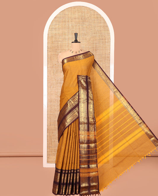 Mustard Plain Chettinad Cotton Saree, Complemented by a Contrast Rettai Pettu Zari Maroon Border of Temple, Coin, Elephant, and Peacock Designs, Subtly Striped Pallu, and Paired with a Matching Blouse