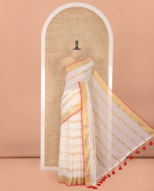 Cream Khadi Mul Cotton Saree, Gleamed up with Zari Stripes All Over Its Body, Subtle Gold Zari Border, Self-Pallu with Tassels, and Paired with a Matching Blouse