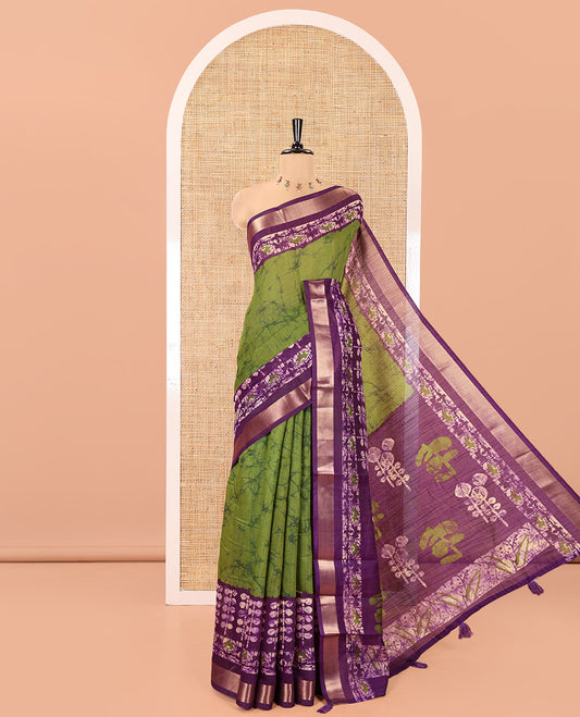 Green Linen Cotton Saree, Adorned with Shibori Printed All Over Its Body, Complemented by a Contrast Batik Printed Zari Border, Floral Printed Pallu, and Paired with a Contrast Blouse