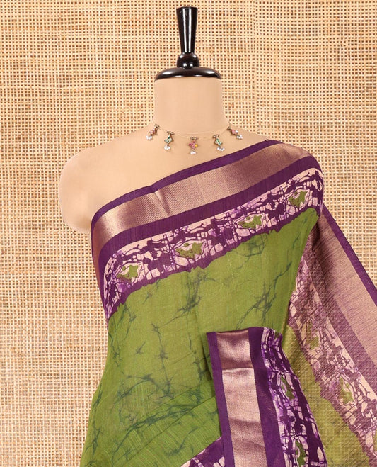 Green Linen Cotton Saree, Adorned with Shibori Printed All Over Its Body, Complemented by a Contrast Batik Printed Zari Border, Floral Printed Pallu, and Paired with a Contrast Blouse