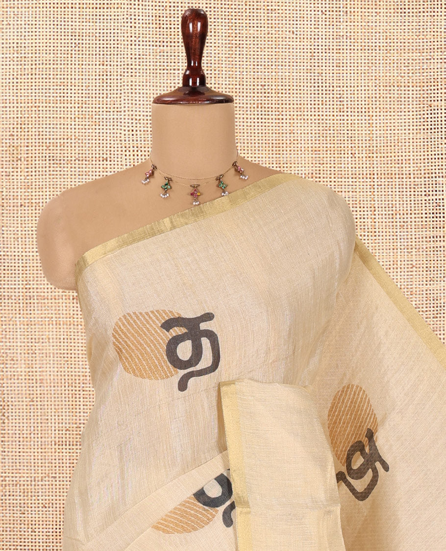 Gold Tissue Linen Saree Features Tamil Letter Print, a Piping Border, and a Matching Blouse