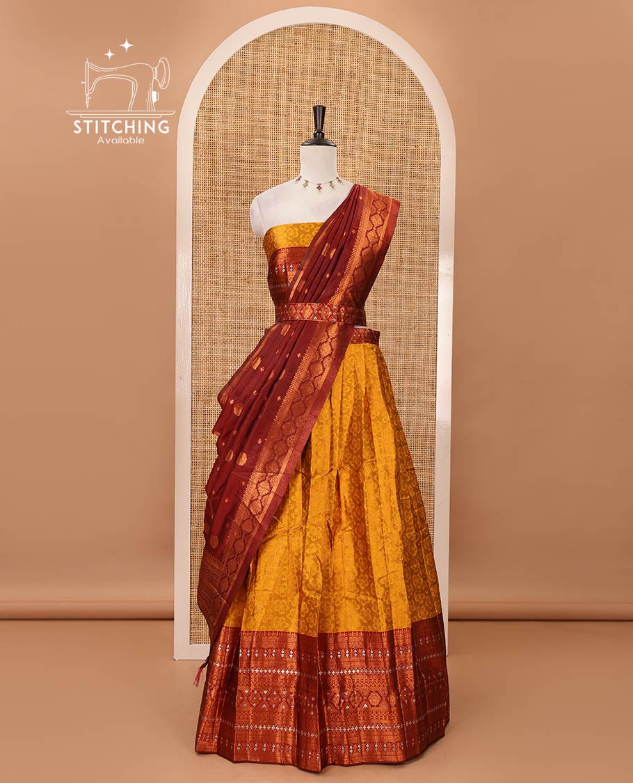 Mustard semi-banaras half-saree, embossed & contrast traditional zari border skirt,blouse of embossed & zari work & contrast-maroon zari design dhavani