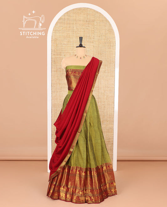 Green half-saree, plain with big contrast traditional zari motifs steeped border skirt, matching blouse and a plain zari border contrast dhavani