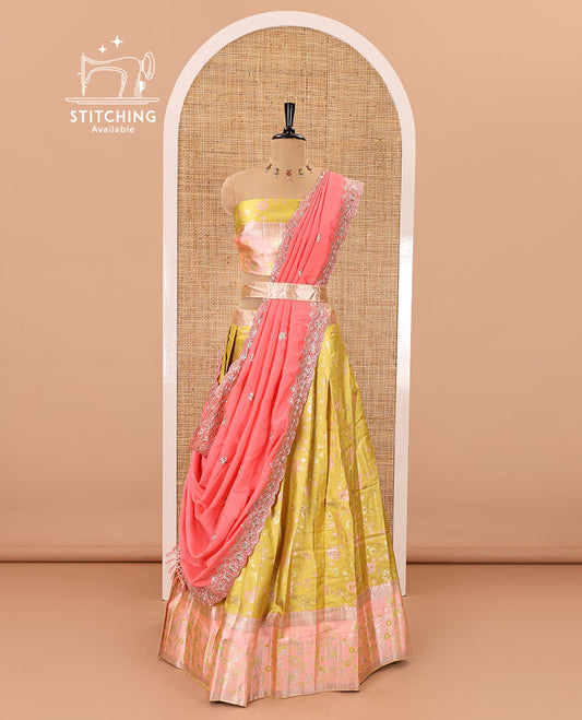 Yellow banarasi half-saree, floral jaal thread weave with contrast floral thread bordered skirt, a matching blouse, and scallop embroidered dhavani with belt