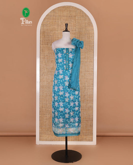 Blue churidar material set, floral print with thread outlined organza top, plain santoon bottom, and floral vine sequins embroidered organza dupatta