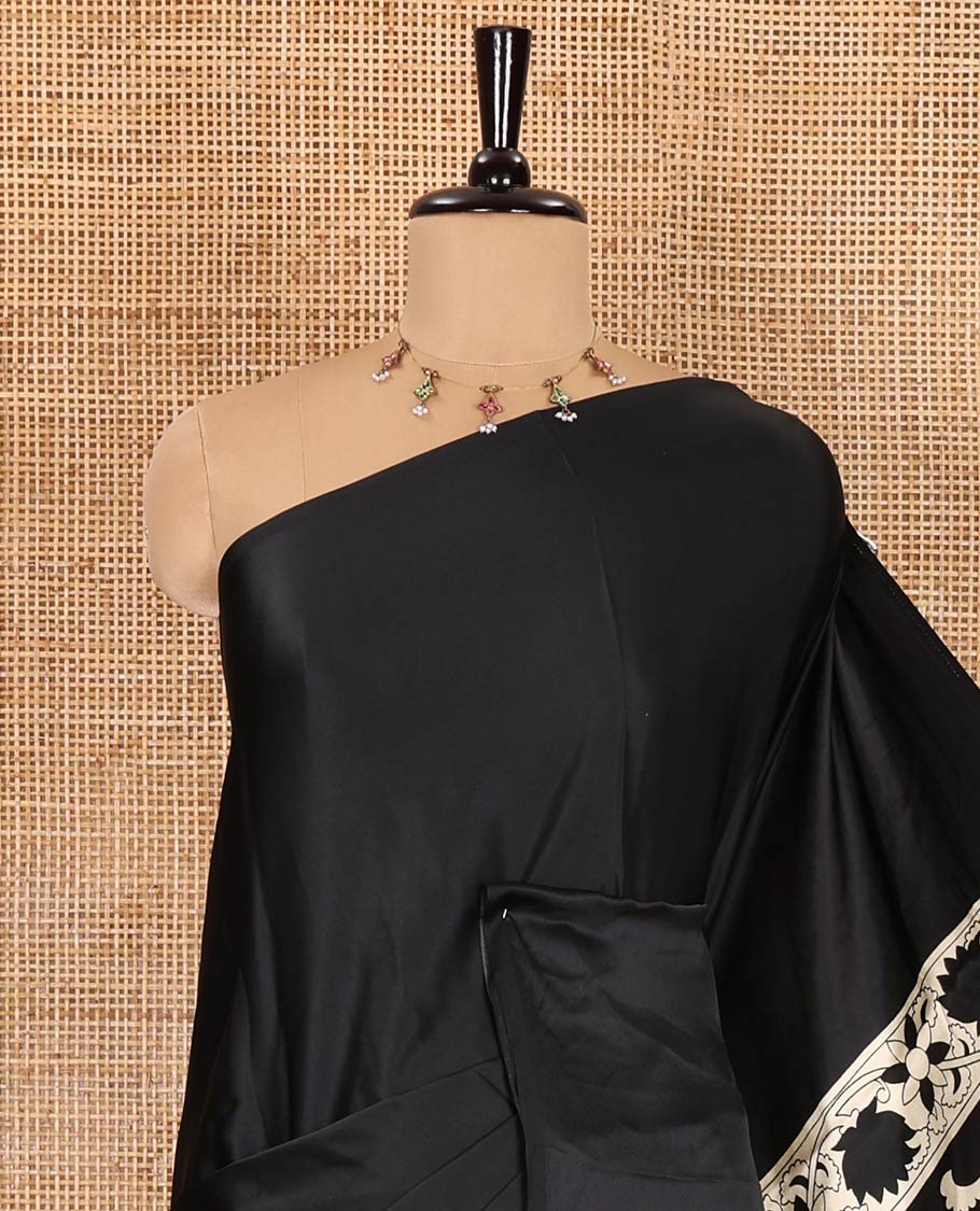 Chikku-black half-and-half plain and kalamkari floral printed satin crepe saree, plain border, pallu of floral vine and peacock printed, and kalamkari floral printed blouse