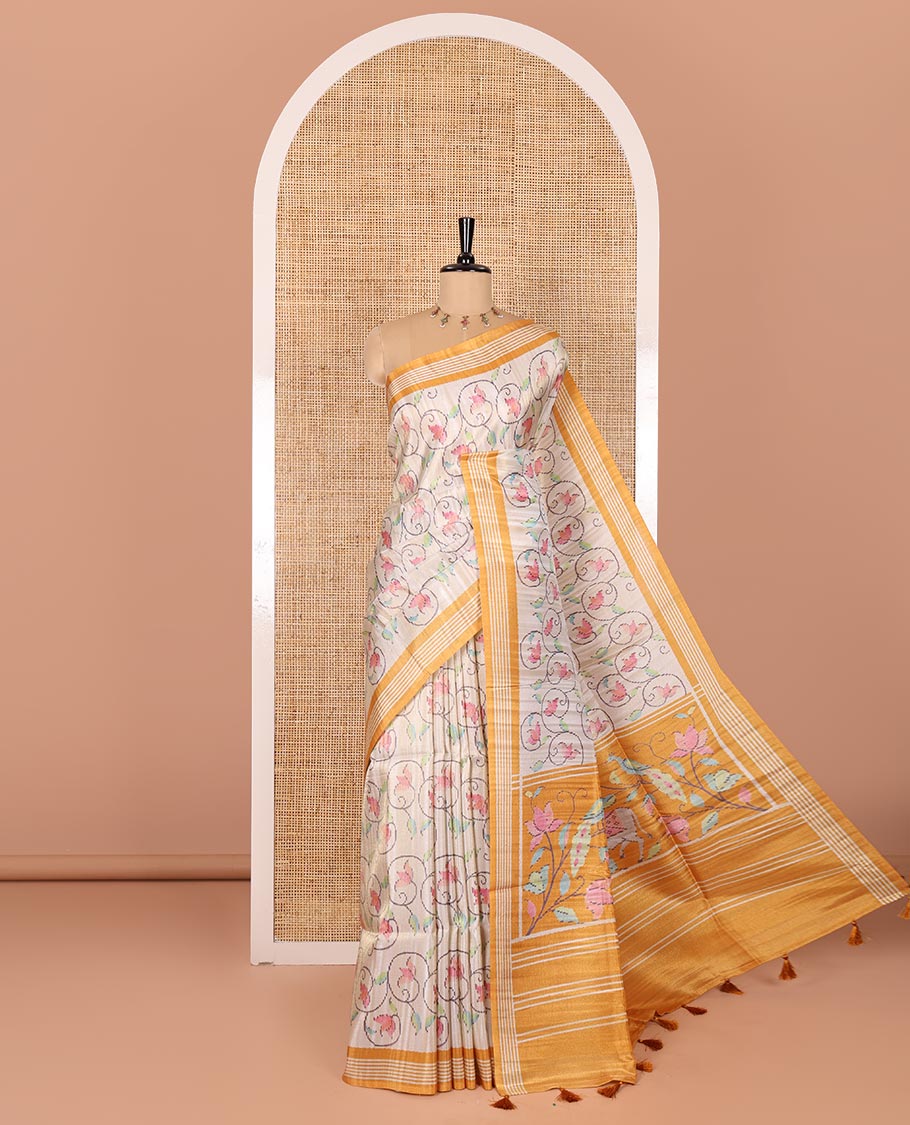 Chikku-yellow floral vine printed tissue patola saree, contrast striped border, pallu of floral and Pichwai cow motifs print, and a plain blouse