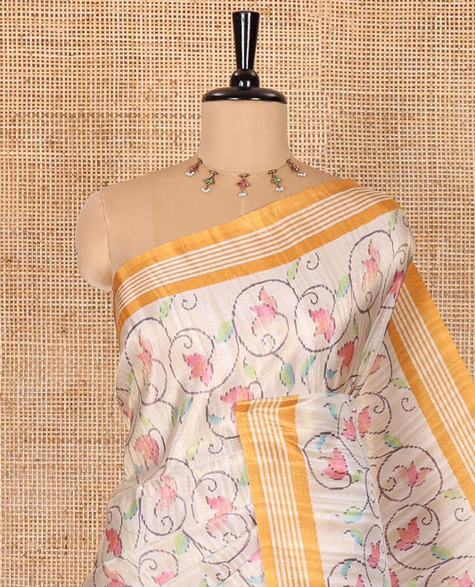 Chikku-yellow floral vine printed tissue patola saree, contrast striped border, pallu of floral and Pichwai cow motifs print, and a plain blouse